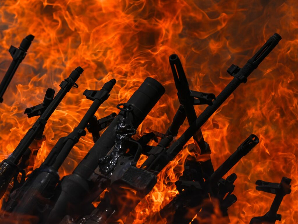 PKK fighters cast weapons into fire to mark start of disarmament