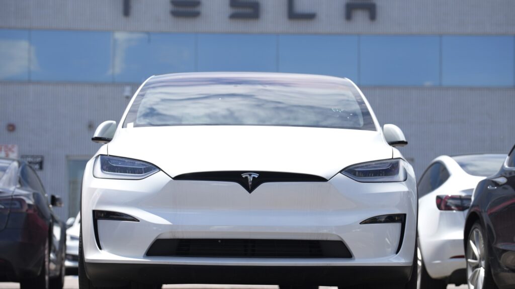 Tesla profits slide 16%, despite Elon Musk’s pivot back to his companies : NPR