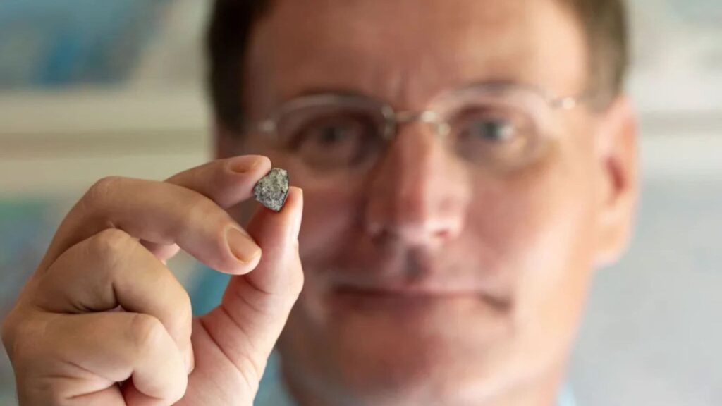 UGA researcher Scott Harris holds a piece of the McDonough Meteorite.