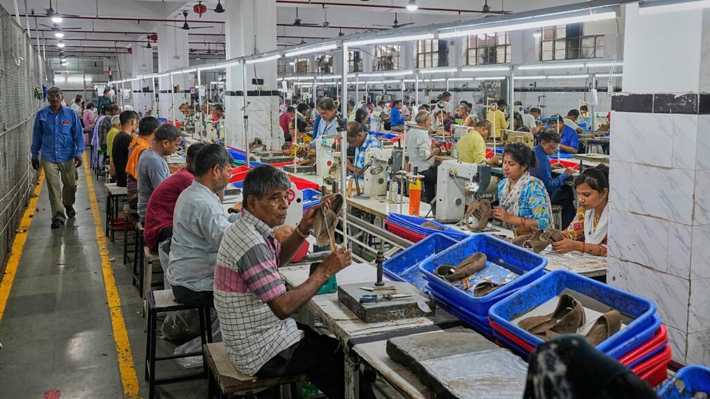 Workers at a manufacturing unit making leather footwear in Agra