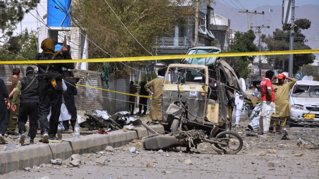 Rescue workers and security officials examine damaged vehicles at the site of a powerful car bombing, in Quetta, Pakistan, Tuesday,