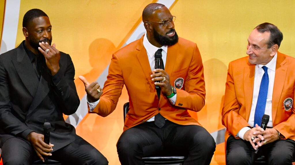 LeBron James, center, shares a light moment with Dwyane Wade, left, and Mike Krzyzewski, during the enshrinement for the 2008 USA Basketball Men's National Team in the Basketball Hall of Fame, Saturday, Sept. 6, 2025, in Springfield, Mass. (AP Photo)